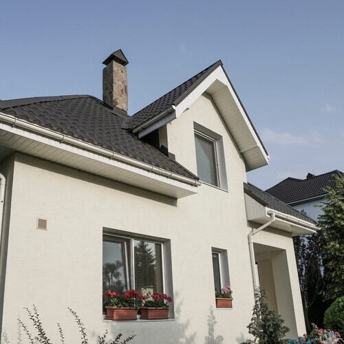 A new house with a garden in a rural area under beautiful sky