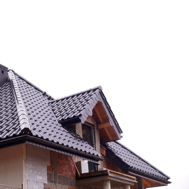 home with a dark gray clay tile roof