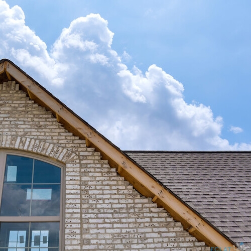 Roofing construction on a part of the new house covered in asphalt shingles