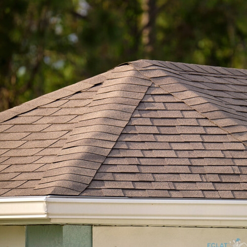 Closeup of house roof top covered with asphalt or bitumen shingles. Waterproofing of new building