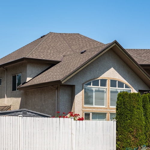 Beautiful exterior house in rural suburban neighborhood. Real Estate Exterior Front House on a sunny day in countryside. Big house with front yard and fence. Beautiful house in a perfect neighborhood