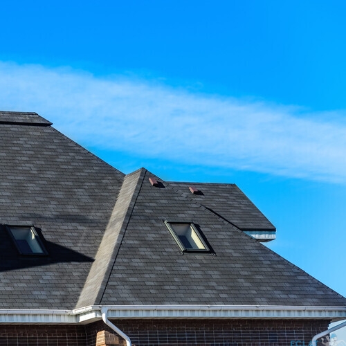 chimney on the roof of the house against the blue sky