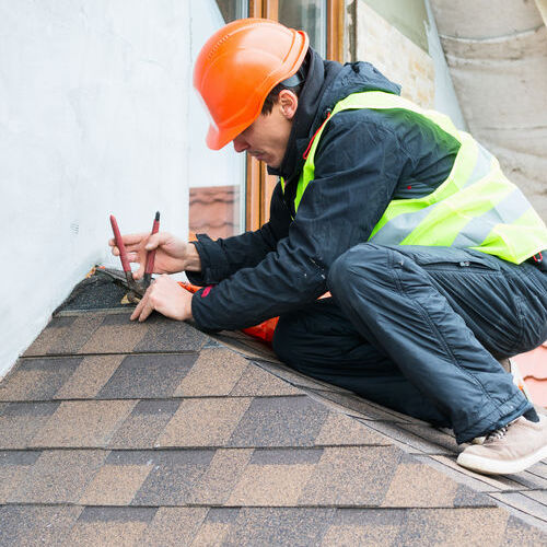A Roofer Works on a Roof Repair.