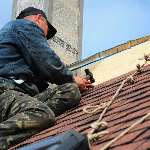 A Roofer Repairs Shingles.