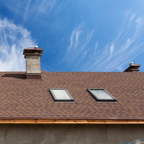 New roof with skylight, asphalt roofing (shingles) and chimney. Roof with mansard windows .