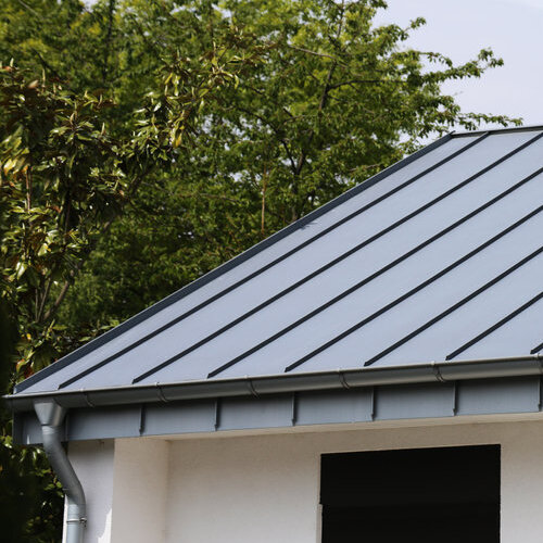 Building with standing seam metal roof.