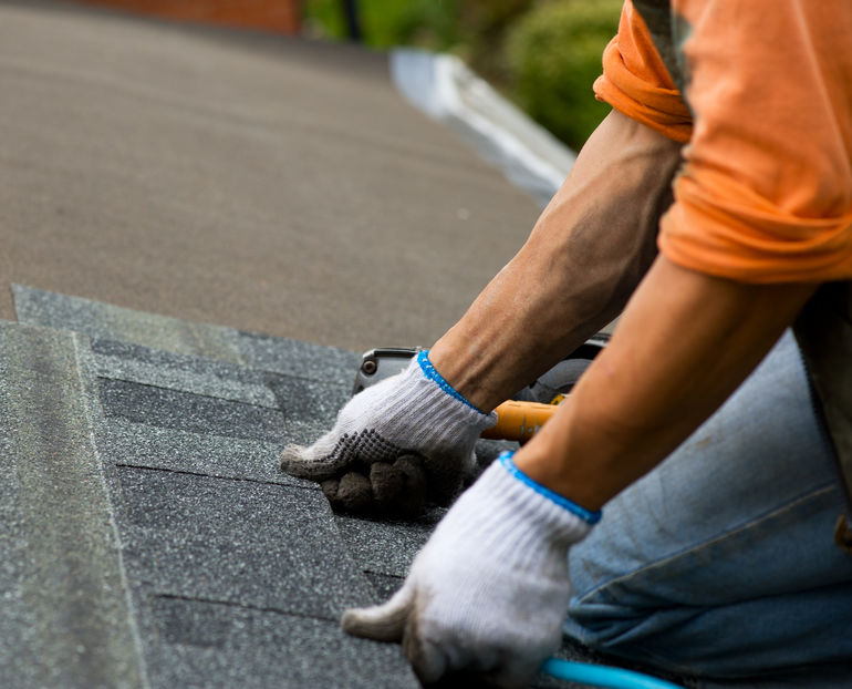 Roofer Installing New Replacement Asphalt Shingles