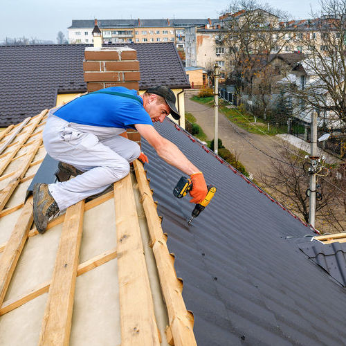 Contractor Working on Metal Roof Installation