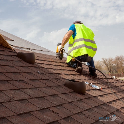 Roofer Replacing Red Asphalt Shingles on Roof