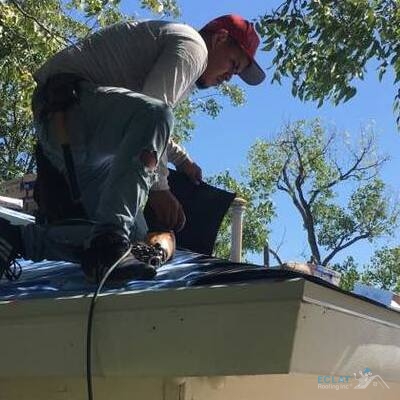 A Roofer Installs Shingles