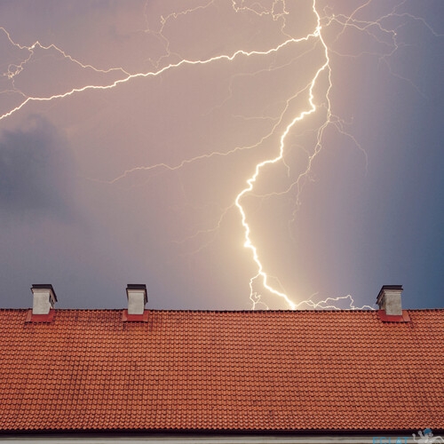 Thunderstorm with lightening over the roof at night